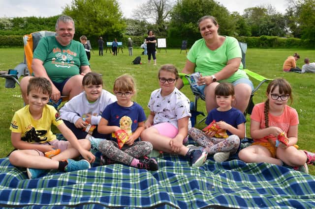 Kev and Rhea Musgrove with their children , from - Freddie 7, Georgie 8, Tillie 5, Izzie 10, Maddie 5 and Lottie 7 picnicking on Scopwick playing field.