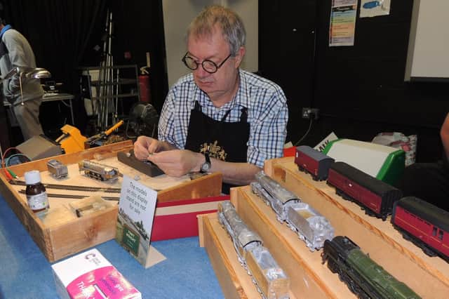 Expert modeller Tony Wright of Little Bytham, cleaning up the cylinder castings on a model Britannia locomotive at the model railway show in Sleaford.