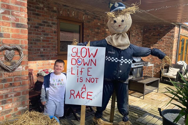 Melanie Horn took this photo of her grandson Noah and his policeman scarecrow with an important safety message to drivers.
