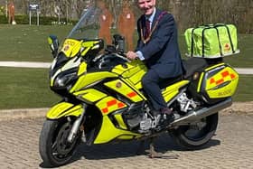 Steve Roberts tries for size an earlier Freemasons' donated motorbike, called simple Mark Mason.