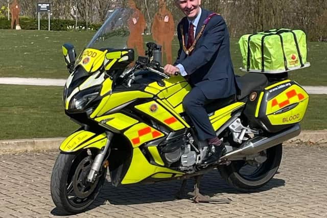 Steve Roberts tries for size an earlier Freemasons' donated motorbike, called simple Mark Mason.
