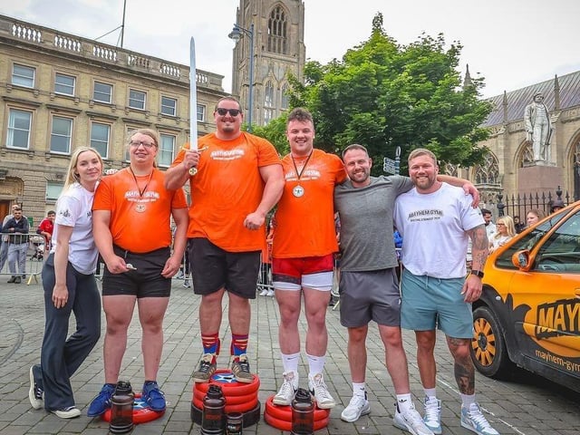 The open category podium: 1st: Dean Mason, 2nd: Luke Ogbourn, 3rd: Finley Roberts. Pictured with them are (second from right) Darren Andrew, of sponsor Independent Grab, (sponsor), and Thomas and Sarah Chenery, organisers of the event and owners of Mayhem Gym.