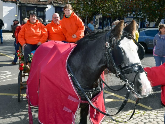 Pollyanna the pony, of Garner's Wheelwright shop in Revesby, leads Sheenagha Lee-Farrah, Daniel Garner and Sophie Moore into Horncastle town centre.