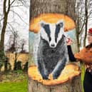 Mural artist Nikita Spires with her badger mural on Eastfield Road.