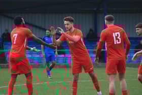 Joe Smith (centre) is congratulated after netting Sleaford's winner. Photo: Ollie Atkin.