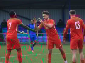 Joe Smith (centre) is congratulated after netting Sleaford's winner. Photo: Ollie Atkin.