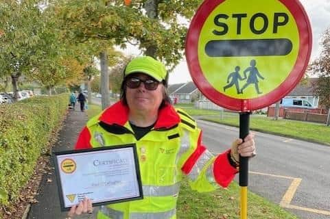 Lollipop man Paul O'Callaghan with his long service award.