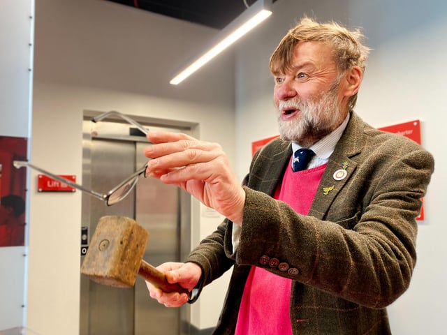 Stephen Bunney, auctioneer for the Charity Auction takes a bid from a member of the public.