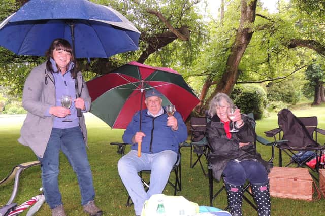 Under cover at the Rauceby Hall jubilee picnic, from left - Claire, Roger and Gillian Enstone.