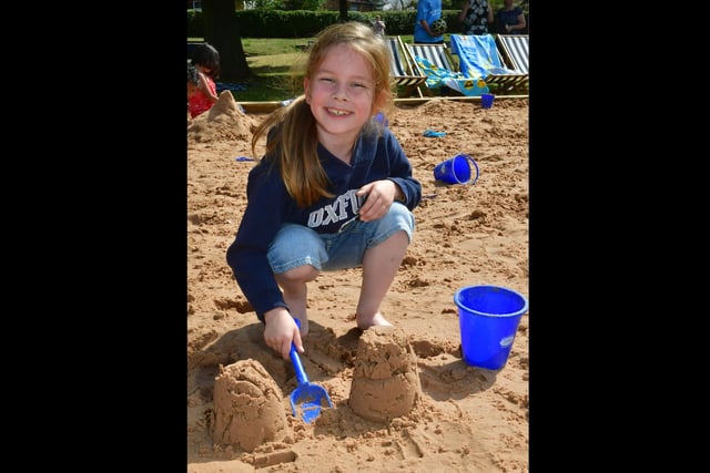 Kane Scarbro, aged seven, enjoys playing in the sand at the beach event in Boston's Central Park.