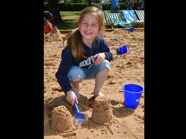 Kane Scarbro, aged seven, enjoys playing in the sand at the beach event in Boston's Central Park.