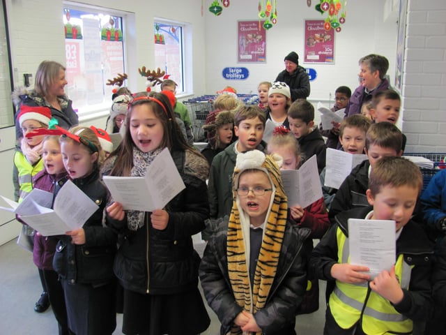 Children from Market Rasen Primary School carol singing at the town's Co-op to raise funds for iPad devices to use in class.