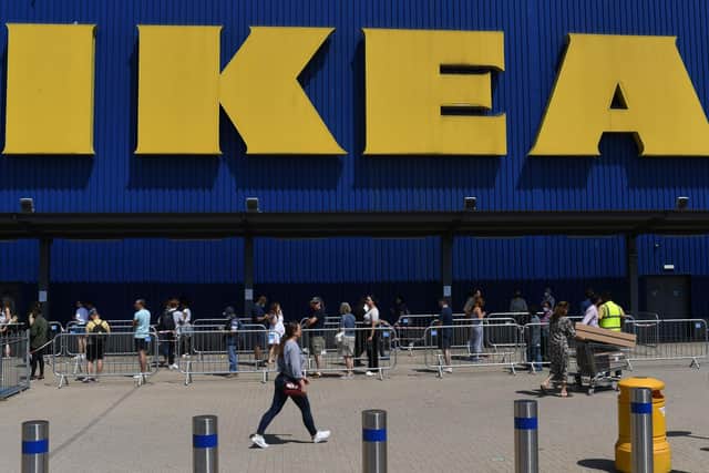 Members of the public queue outside an Ikea store. (Photo by DANIEL LEAL-OLIVAS/AFP via Getty Images)