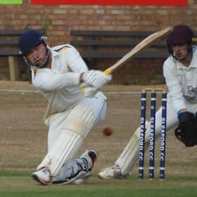 Sleaford's Ben Lambert sweeping against North Scarle.