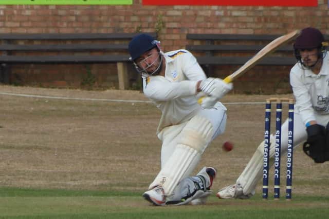 Sleaford's Ben Lambert sweeping against North Scarle.