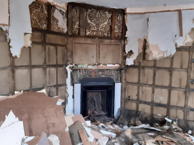This part of the building was previously used for suit hire. However, behind the shop fittings, chipboard, plaster, more than half-a-dozen layers of wallpaper, a layer of Hessian, an oak-panelled office with flock wallpaper was waiting to be found. Shane described this as 'the most impressive find'. "It's beautiful, isn't it?" he said. Local historian Neil Wright has been helping Shane with the history of the site. He told The Standard that both 20 and 22 South Street (where Cheers was located) dates from the 18th century. The buildings were owned by Kerchever Thompson, one of the wealthiest merchants in Boston. "We do not know where he lived, but Packhouse Quay was the main landing place in the port of Boston until the 1880s so No.20 might have been his home as it was right on the quay." Thompson's wealth is indicated by the fact that when he retired he moved to Ketton Hall in Rutland and his portrait was painted by Wright of Derby, he added.