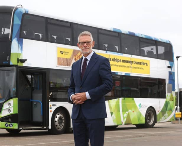 Darren Roe with an electric bus