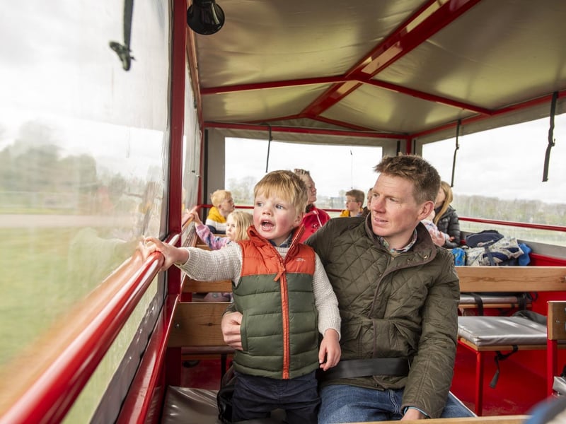 Rufus Parker-Garrick, age three, takes a tractor and trailer ride with dad Kevin Garrick.