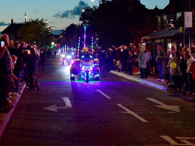 The crowd clapped and cheered as the riders passed by.
