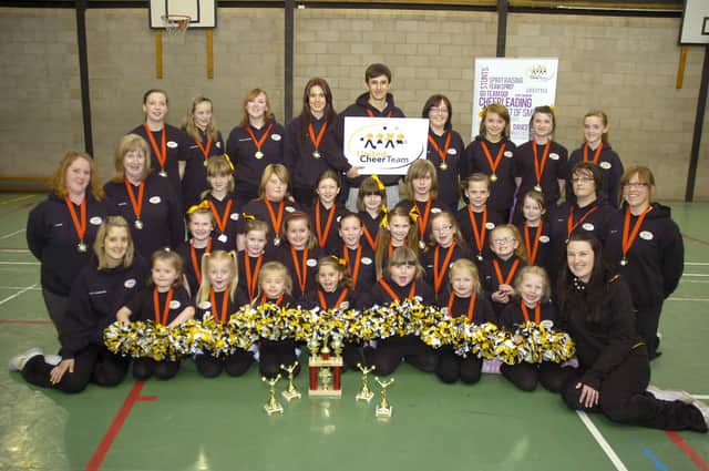 Boston's United Cheer Team squad with medals and trophies in 2012.
