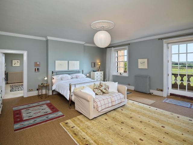 A bedroom with a balcony.