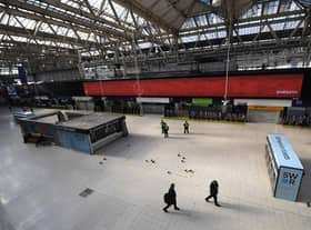 Police Office and National Rail Staff are seen at an empty Waterloo Station in London (Photo: Alex Davidson/Getty Images)