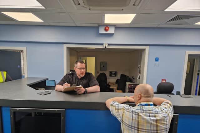 Custody Sgt Andy Young ar the reception desk.