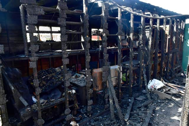 The side of the destroyed wooden outbuilding which housed Mr Malone's collections.