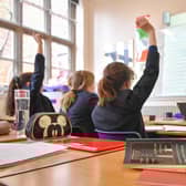 File photo dated 12/09/18 of a teacher and students in a classroom. Poorer pupils are less likely to get into top-performing comprehensive schools than their peers even if there is one in their local area, a study by charity group Sutton Trust has found. Issue date: Thursday January 11, 2024.