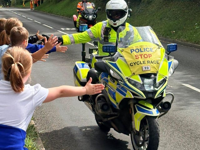 Police escort riders take time to greet crowds of school pupils in Caistor. Photo: LCC