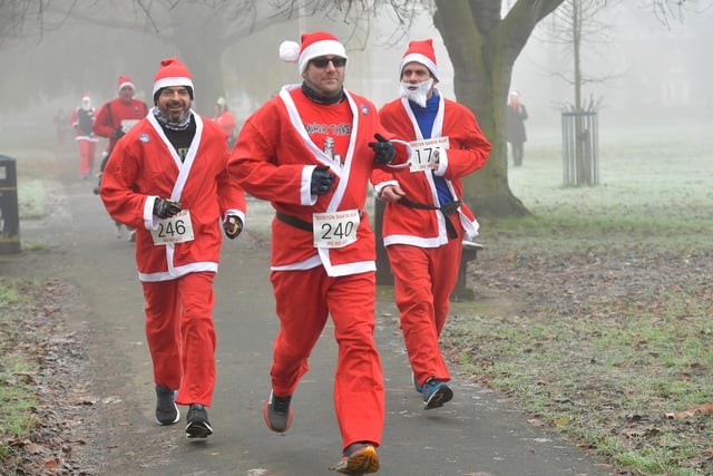 Santas on the run, heading out of Central Park.