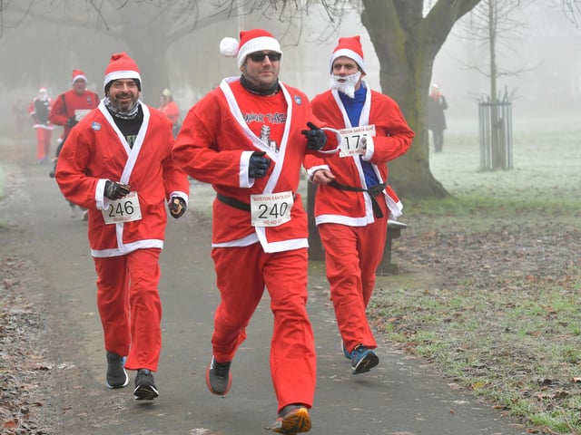 Santas on the run, heading out of Central Park.
