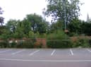 The overgrown garden behind the wall of Money's Yard car park, set to become a new riverside park in the town centre.