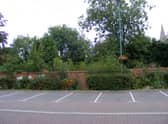 The overgrown garden behind the wall of Money's Yard car park, set to become a new riverside park in the town centre.