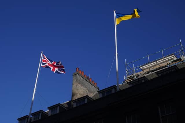 File photo dated 25/02/22 of The Ukrainian flag being flown above 10 Downing Street in London, as the UK's visa schemes for Ukrainian refugees are "lacking in clarity, resourcing and accountability" and are heightening the risk of trafficking and exploitation, according to a report.