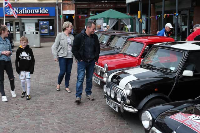 A family looking at the display of Minis.