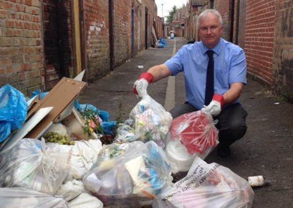 Coun Trevor Young with some of the rubbish that has piled up in an alleyway in Gainsborough South West ward
