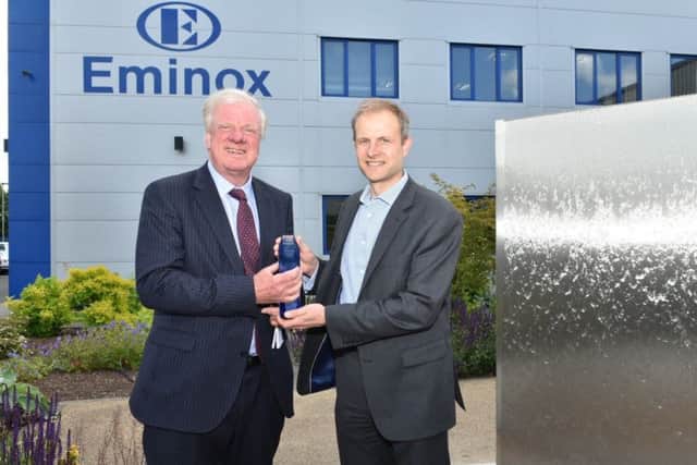 MP Sir Edward Leigh (left) and Hexadex chairman Will Milles unveil a water feature to mark Eminoxs anniversary.