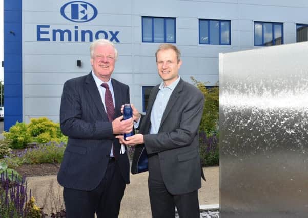 MP Sir Edward Leigh (left) and Hexadex chairman Will Milles unveil a water feature to mark Eminoxs anniversary.