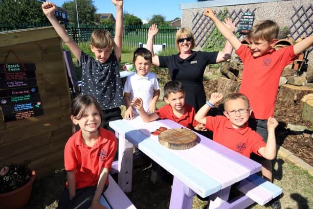 Pictured are Gregory Simpson, aged seven, Dolton Mclaggan, six, Macie OMara, seven, Alfie Grange Smith, six, Angus Mclaggan, nine, Fynn, seven, and Lissa Macfarlane from M&S.