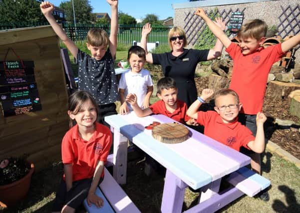 Pictured are Gregory Simpson, aged seven, Dolton Mclaggan, six, Macie OMara, seven, Alfie Grange Smith, six, Angus Mclaggan, nine, Fynn, seven, and Lissa Macfarlane from M&S.