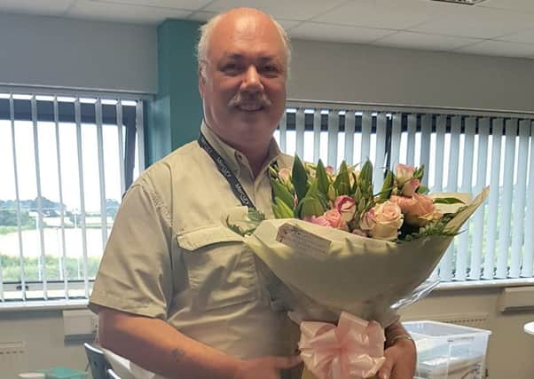 Gainsborough Heritage Society chairman Andrew Birkitt receiving a bouquet of flowers donated by Fabulous Flowers (on behalf of Gainsborough Life)