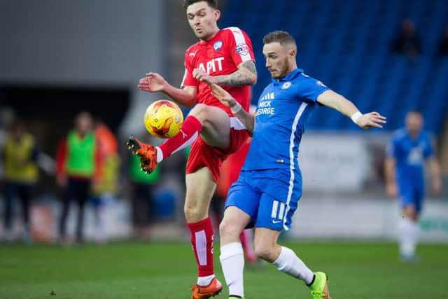 Peterborough vs Chesterfield - Jay O'Shea beats Peterborough's Marcus Maddison to the ball - Pic By James Williamson