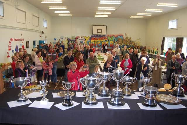 An array of trophies and large crowds at a previous Sturton and Stow Show.