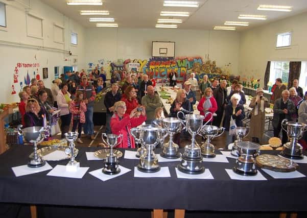 An array of trophies and large crowds at a previous Sturton and Stow Show.