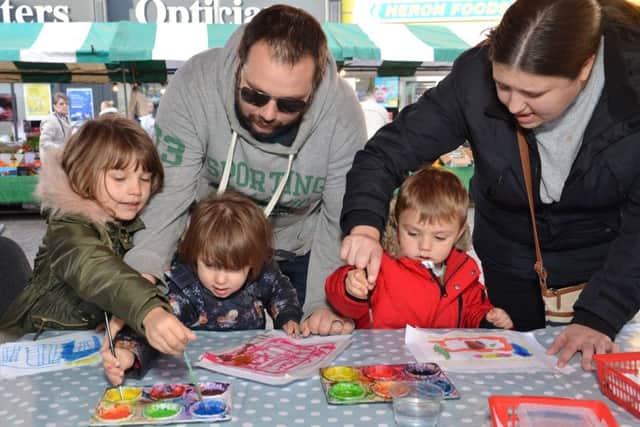 Creating artwork at 'The Big Draw' event are Jennifer Weight, aged seven, and Sophie and George Weight, aged four, with dad Chris Weight and mum Tracy Sellars.