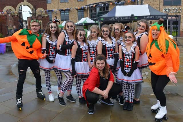 The dance crew at The Studio Gainsborough pose for the camera with a couple of fancy-dress pumpkins on roller skates.