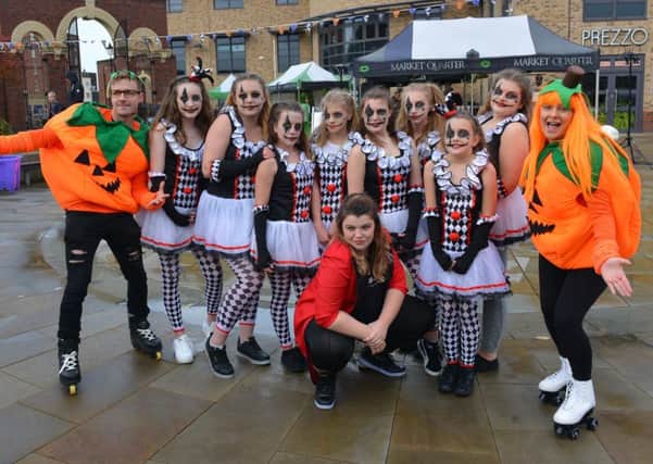 The dance crew at The Studio Gainsborough pose for the camera with a couple of fancy-dress pumpkins on roller skates.