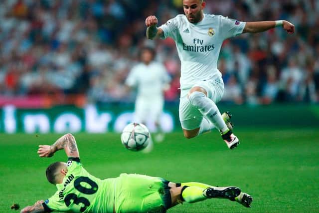MADRID, SPAIN - MAY 04: Nicolas Otamendi of Manchester City makes a tackle on Jese of Real Madrid during the UEFA Champions League semi final, second leg match between Real Madrid and Manchester City FC at Estadio Santiago Bernabeu on May 4, 2016 in Madrid, Spain. (Photo by Gonzalo Arroyo Moreno/Getty Images)