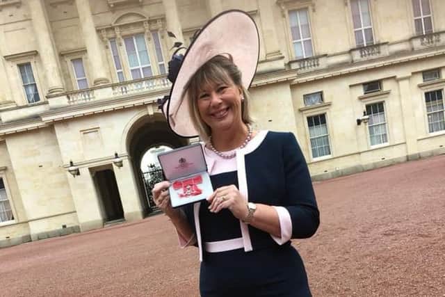 Anne-Maria Newham with her MBE at Buckingham Palace.